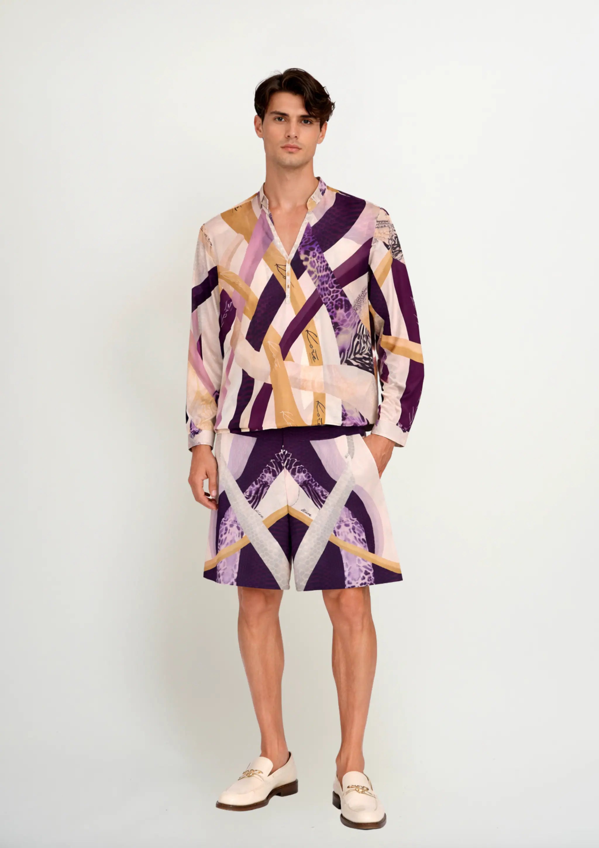 Full-length studio shot of a model wearing a premium men's resortwear co-ord set by Korè Collections, featuring the Blooming Night long-sleeve Korean collar shirt paired with matching printed silk shorts and cream loafers.