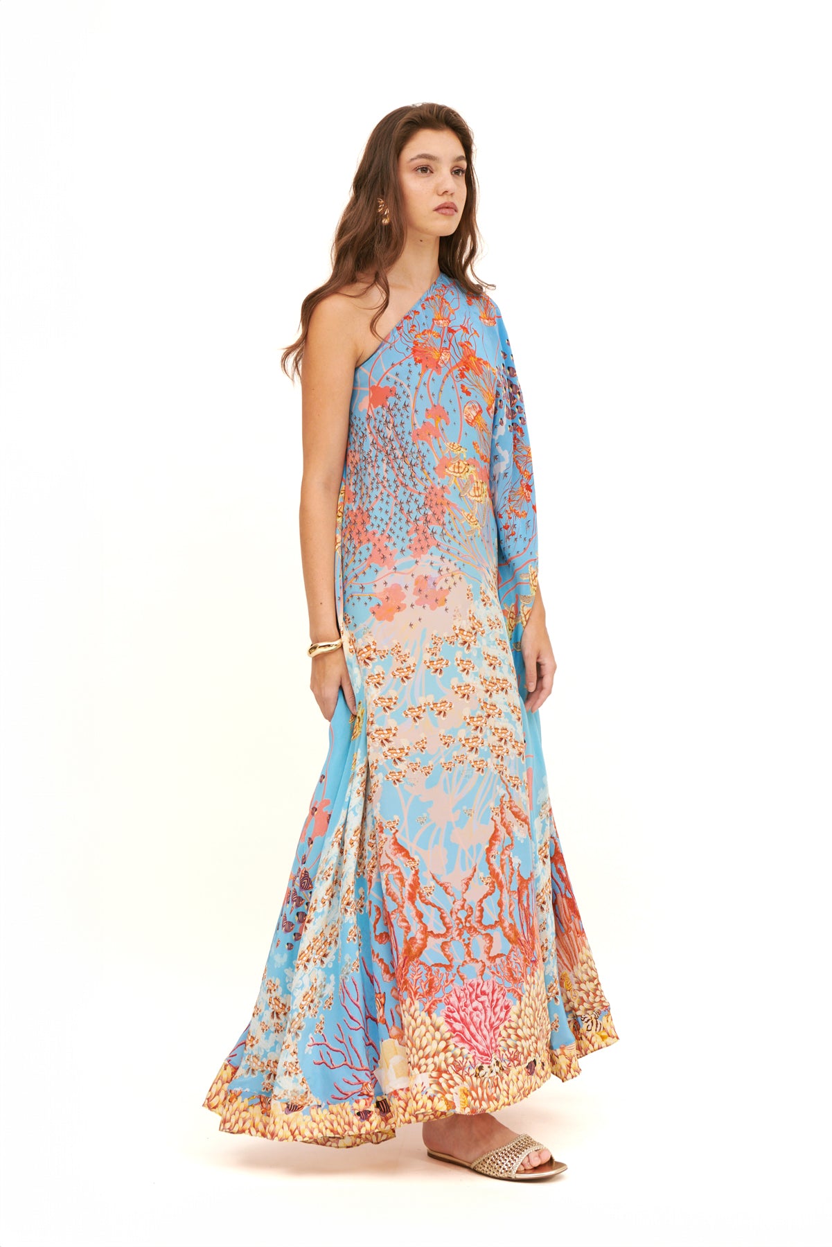 Monoshoulder cape dress with a dramatic silhouette and elegant design for a sophisticated, bold look.