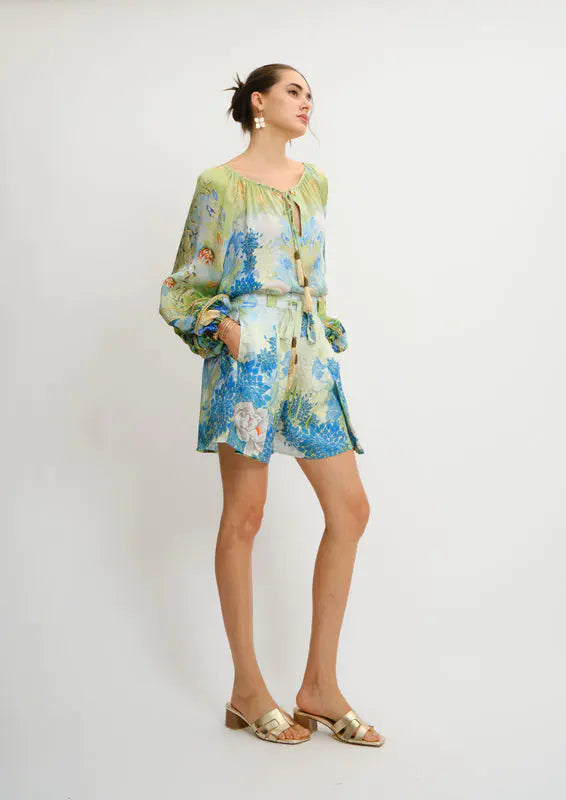 Model wearing Pleated Aura Shorts in Jardin du Jour print by Koré Collections side details
