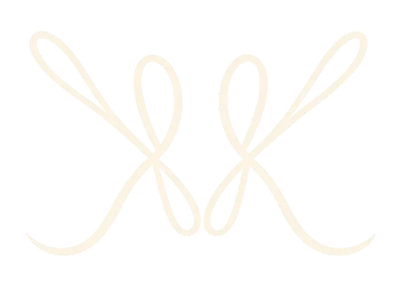 A pair of delicate, pale cream-colored metal horseshoes displayed side-by-side on a solid white background.